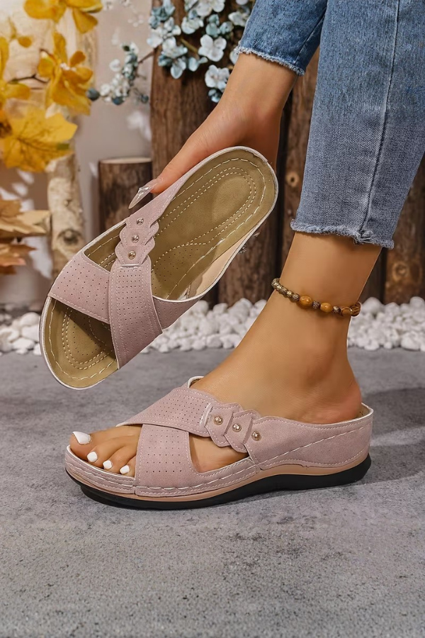 Lightweight women's wedge sandals with perforated details. Offers cushioned support for all-day comfort & style.