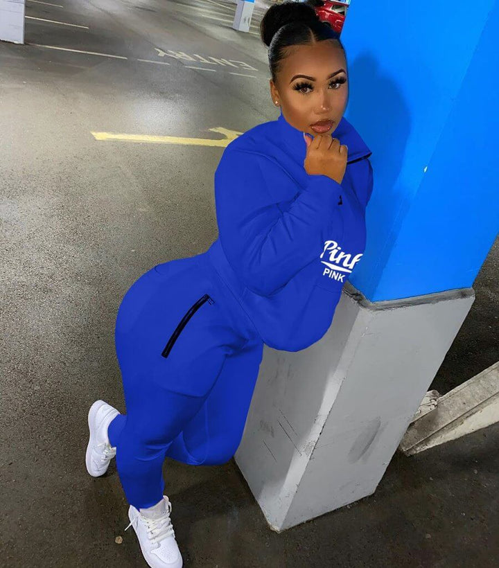 Versatile women's pink lettered two-piece athletic set, great for jogging, gym or lounging.