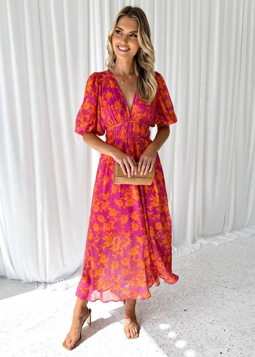 Women's pink orange floral maxi dress with V-neck, short puff sleeves, and a flowing skirt, perfect for summer.