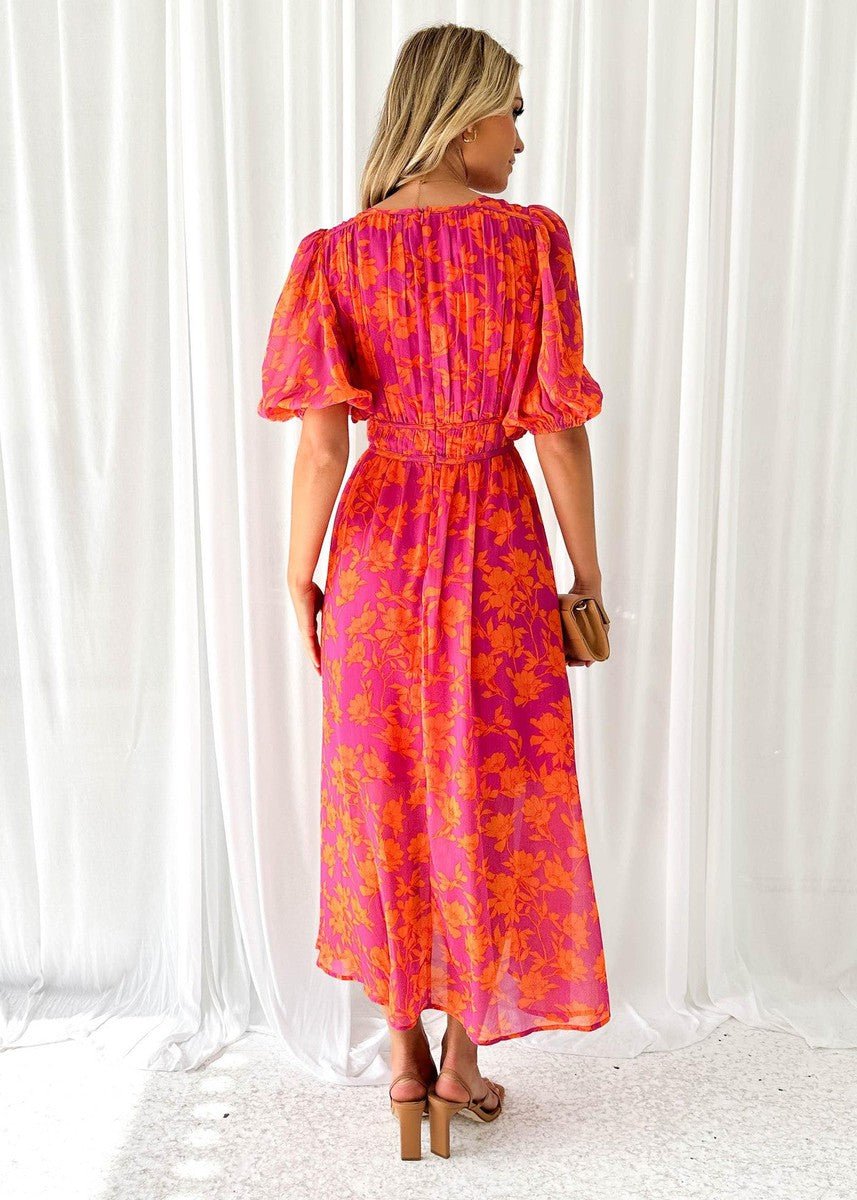Flowing women's pink orange floral maxi dress featuring short puff sleeves and a flattering V-neck design.