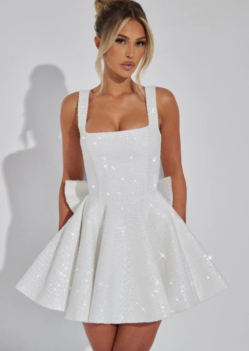 White sequin skater dress for women, featuring a chic bow. Ideal as a homecoming or party dress.