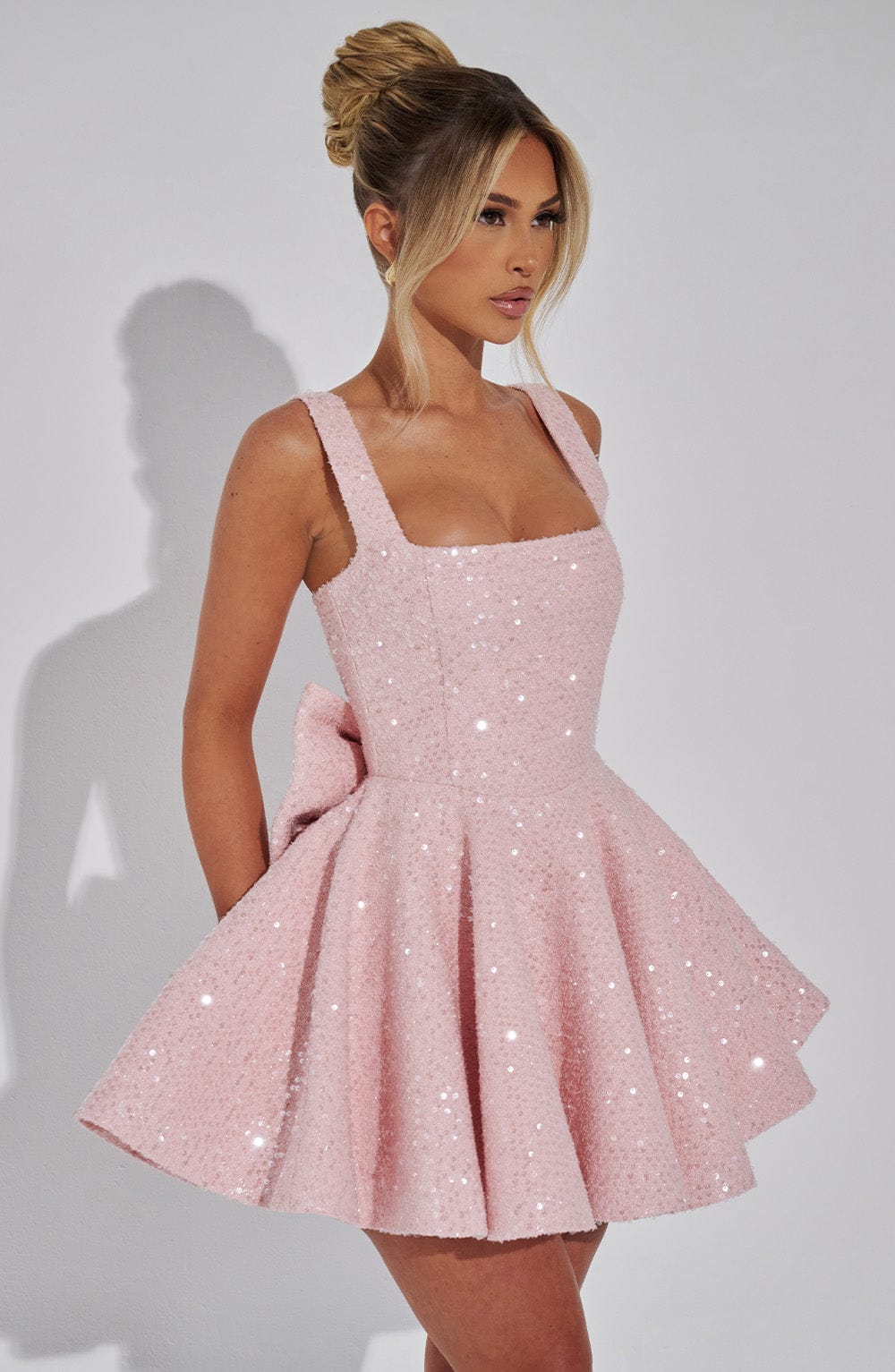 Women's white sequin bow skater dress, a festive party or special occasion outfit.