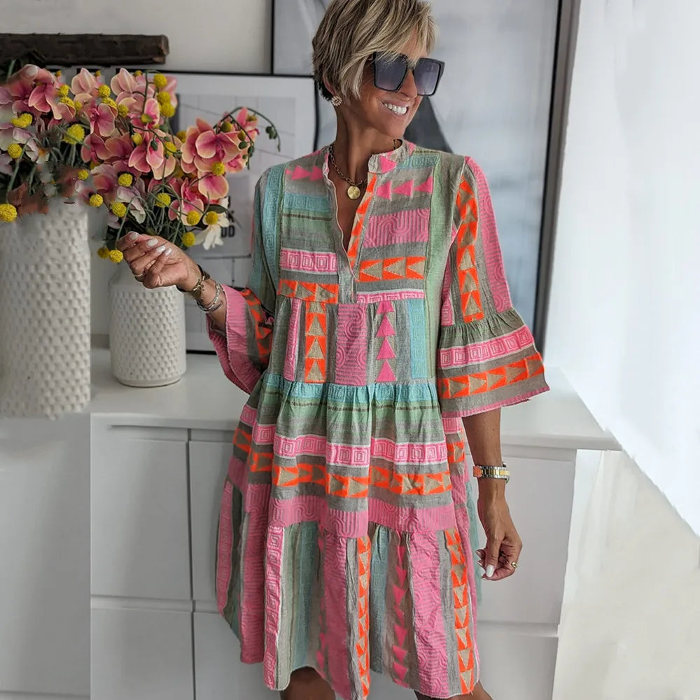 Women's pink tiered mini spring dress with V-neck, 3/4 sleeves & geometric print. Perfect casual day dress.