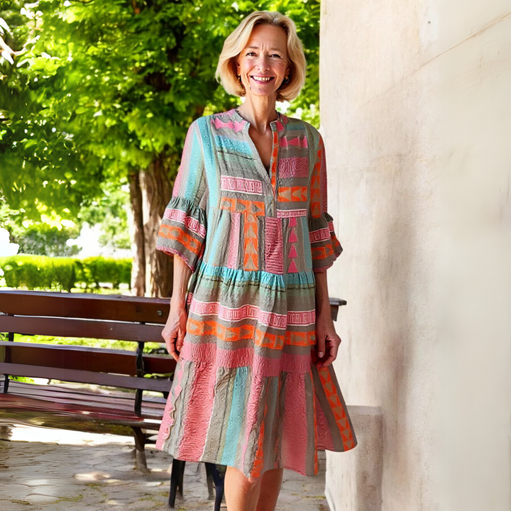 Charming pink printed tiered mini dress for women, featuring a flattering V-neck & comfortable 3/4 sleeves. Spring essential.