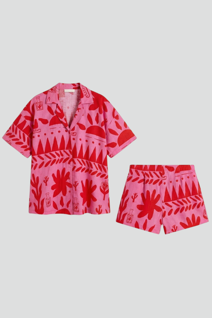 Women's pink tropical print camp collar shirt & high-waisted shorts co-ord set, perfect for summer resortwear.