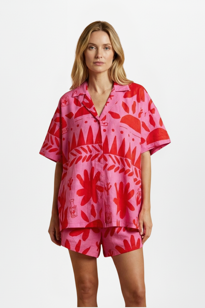 Pink tropical print women's camp collar shirt & matching high-waisted shorts set, ideal beachwear for vacation.