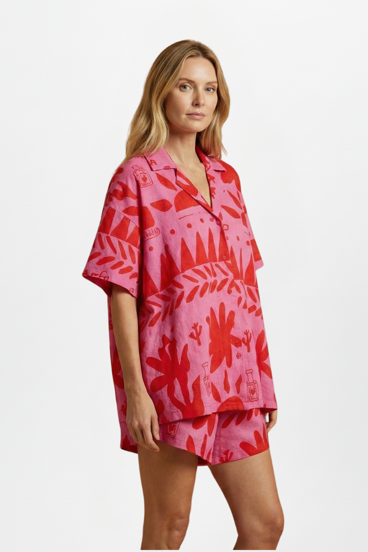 Women's tropical print pink co-ord set: camp collar shirt & high-waisted shorts. Perfect for summer beachwear.
