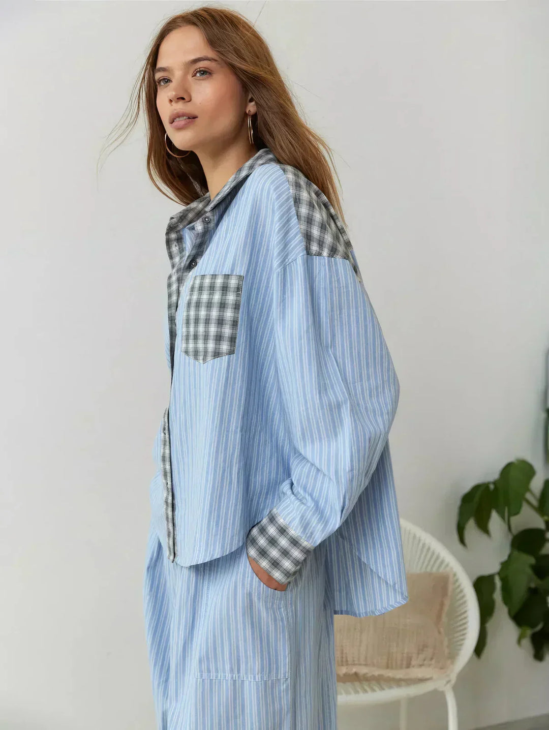 Relaxed fit women's plaid pajama set; button-up shirt and comfortable pants, perfect for loungewear.