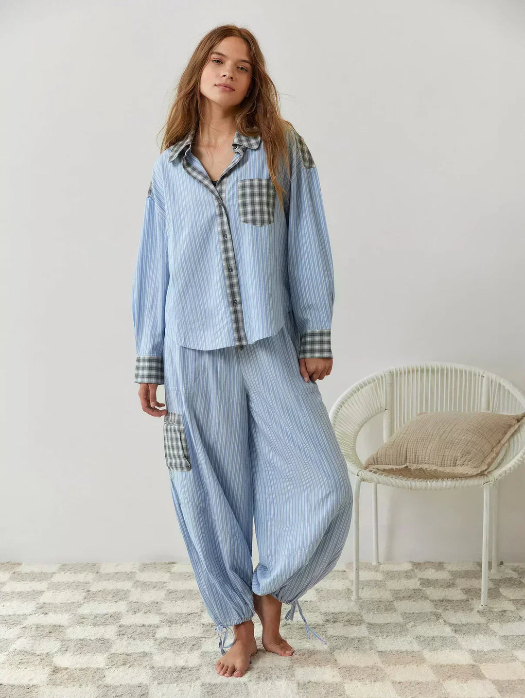 Soft women's plaid button-up pajama set, two-piece with relaxed fit pants, ideal for cozy nightwear.