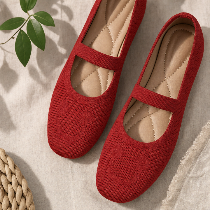 Red Mary Jane ballet flats for women with a playful smiling face & adjustable strap, ideal for comfortable casual footwear.