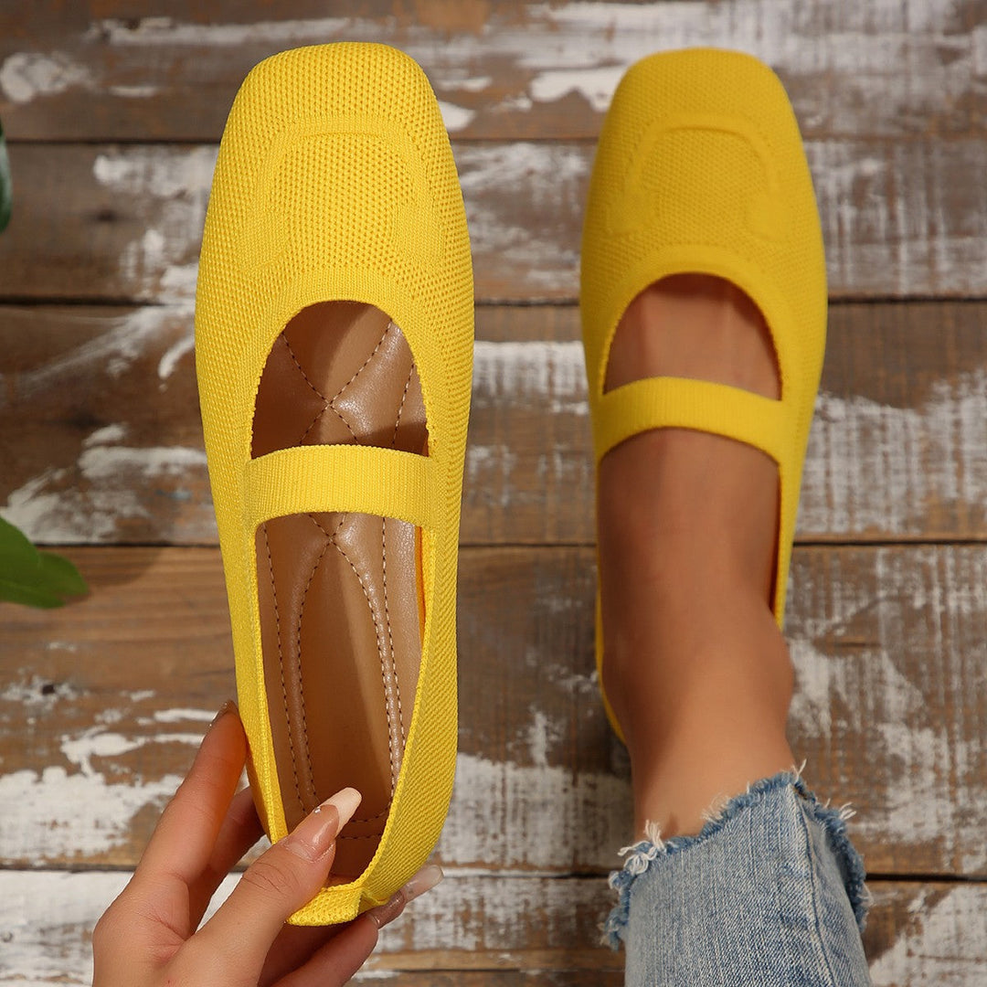 Charming women's ballet shoes: Mary Jane flats featuring a cheerful smiling face emblem and secure adjustable strap.