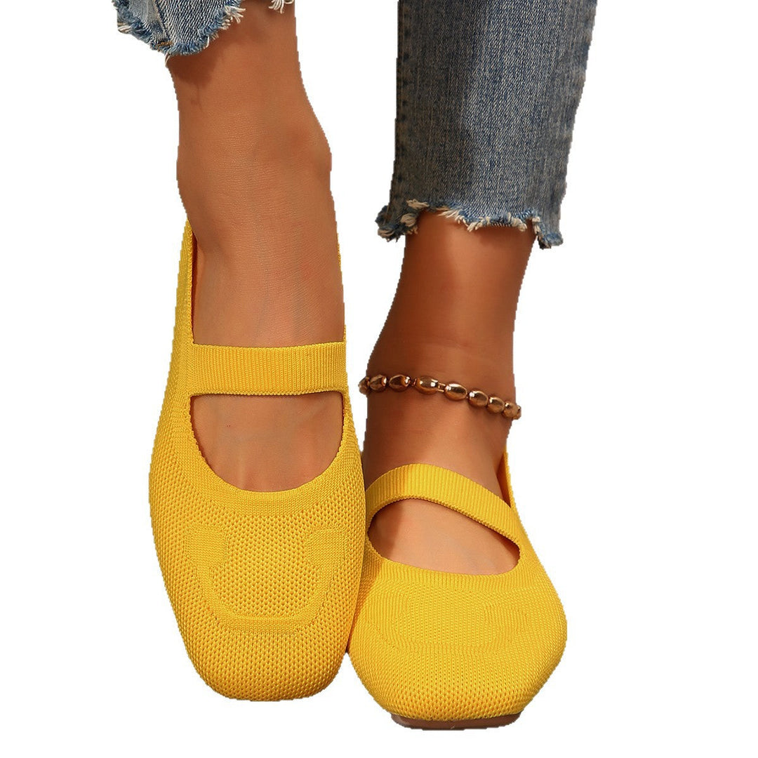 Comfortable women's Mary Jane ballet flats in a vibrant yellow, adorned with a playful smiling face & adjustable strap.