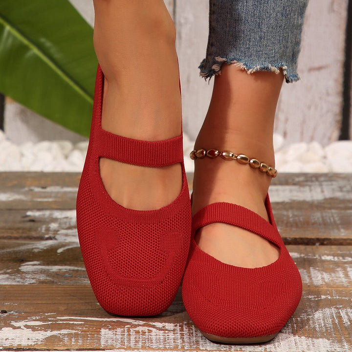 Elegant black Mary Jane flats for women, designed with a cute smiling face detail, offering both comfort and modern style.