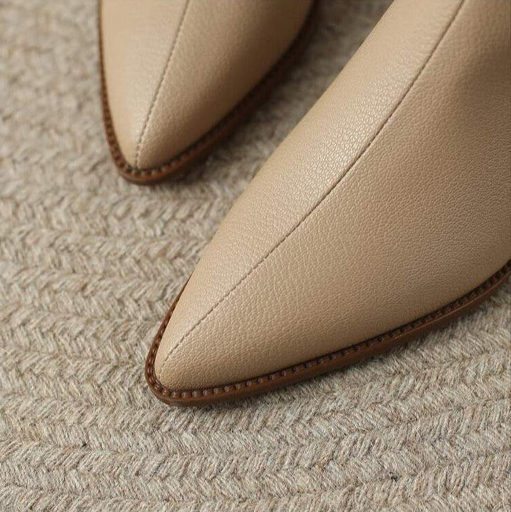 Versatile women's pointed toe ankle boots, comfortable slip-on low heel for any occasion.