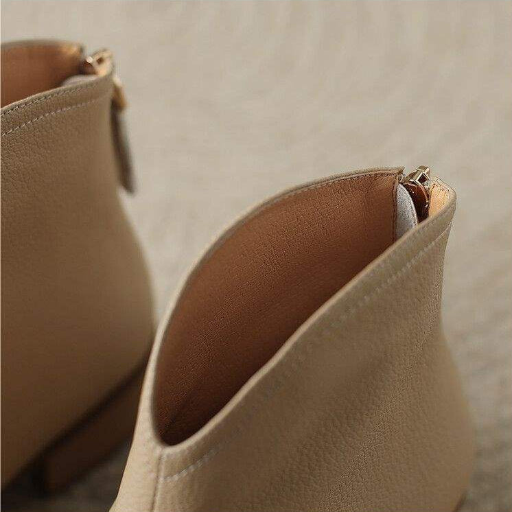Stylish women's pointed toe slip-on ankle boots, low heel for effortless office to evening wear.