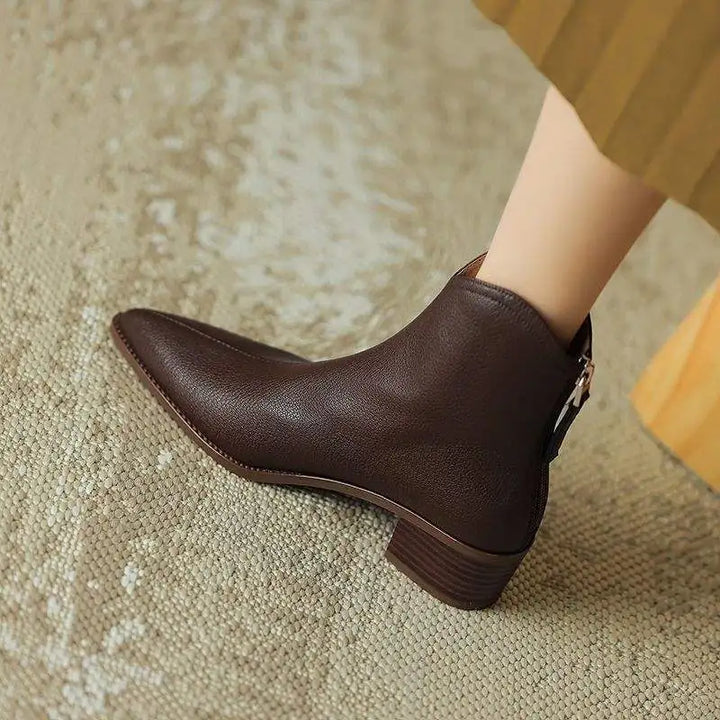 Chic women's pointed toe ankle boots, sophisticated low heel slip-on design.