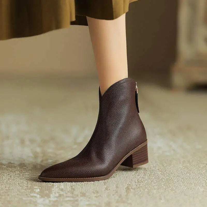 Comfortable slip-on low heel women's ankle boots with elegant pointed toe.