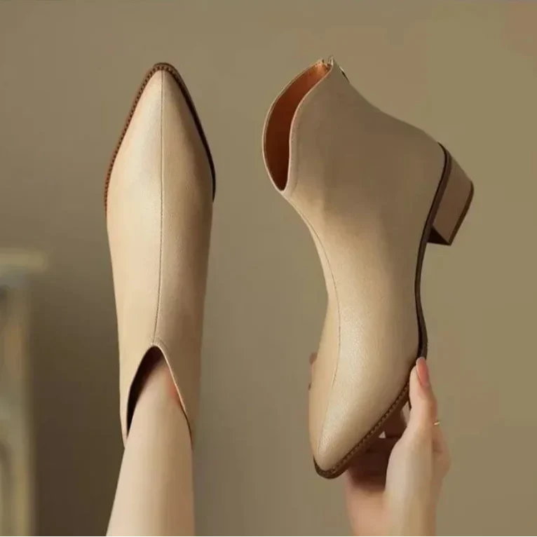Chic sophisticated women's pointed toe ankle boots, low heel slip-on style.