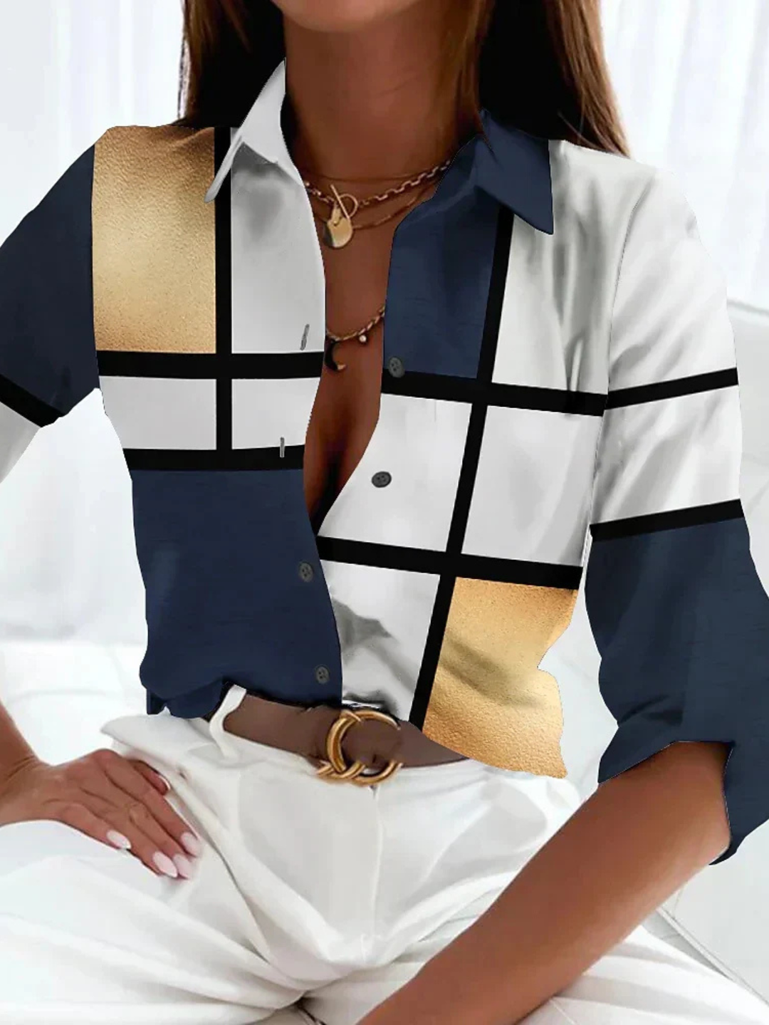 Women's printed button-down blouse with a relaxed fit. Stylish three-quarter sleeve top for casual chic everyday wear.