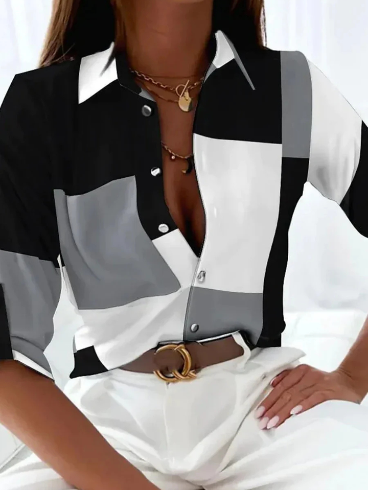 Stylish women's printed button-down blouse. Versatile collared shirt with three-quarter sleeves for casual chic fashion.