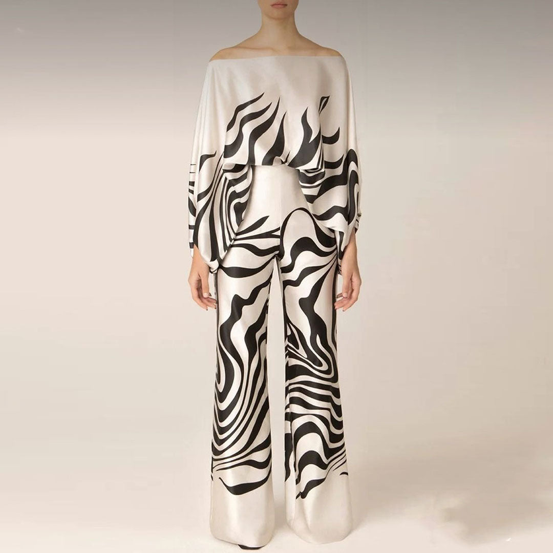 Flowy one-shoulder top & wide-leg pants co-ord set for women. Printed two-piece outfit, perfect for statement looks.