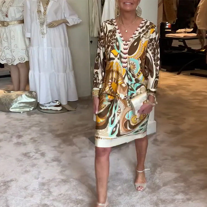 Artistic sunburst print on a women's tunic dress, loose fit and vibrant for casual summer.