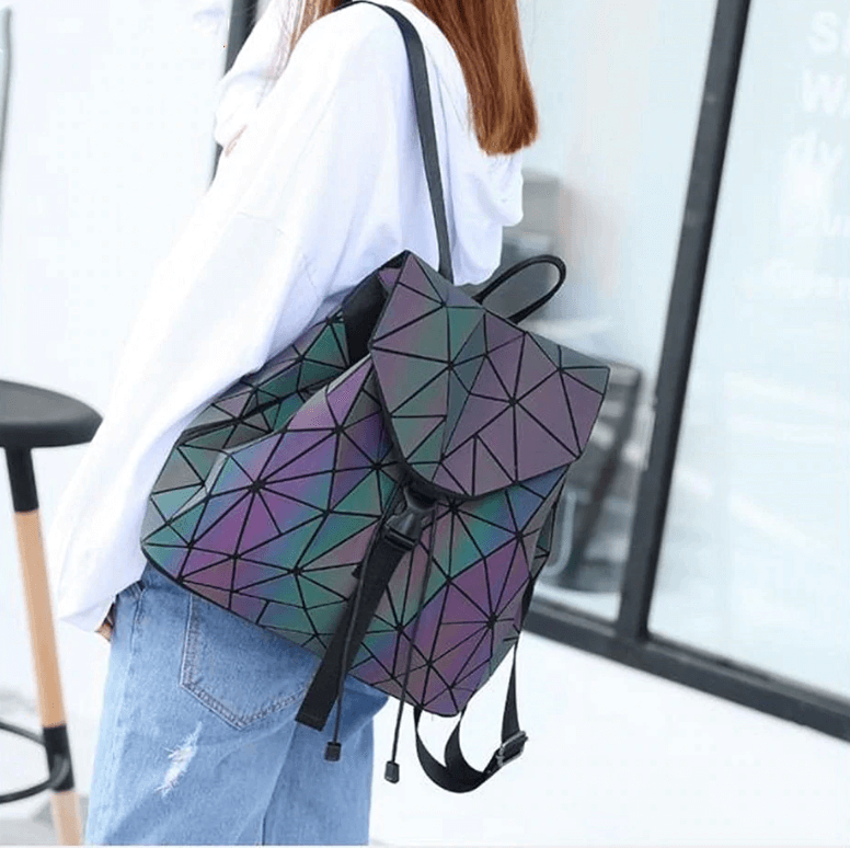 Glowing women's reflective geometric backpack, color-changing in light, unique & modern.