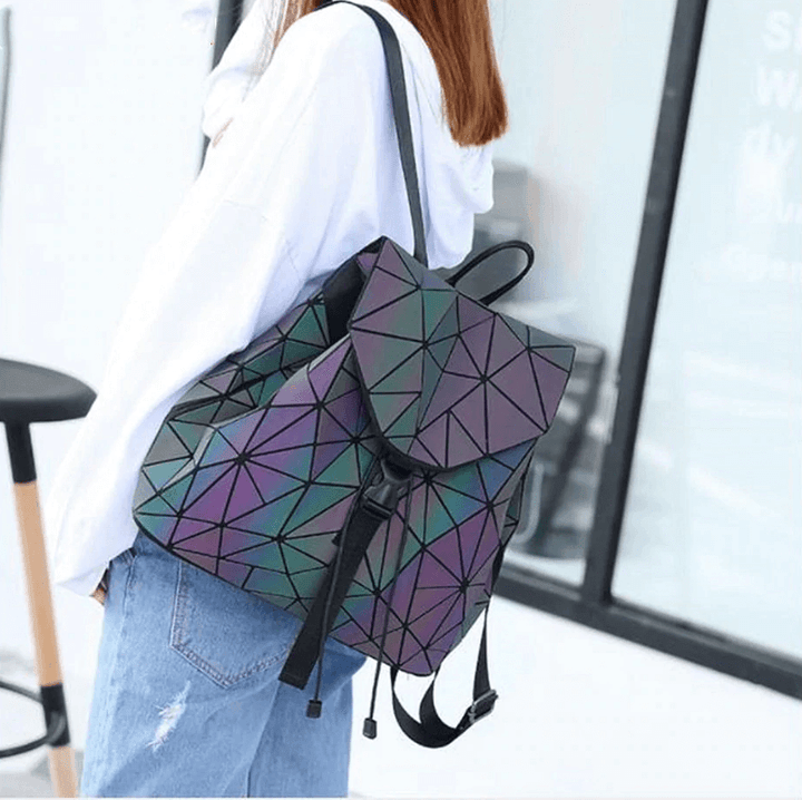Glowing women's reflective geometric backpack, color-changing in light, unique & modern.