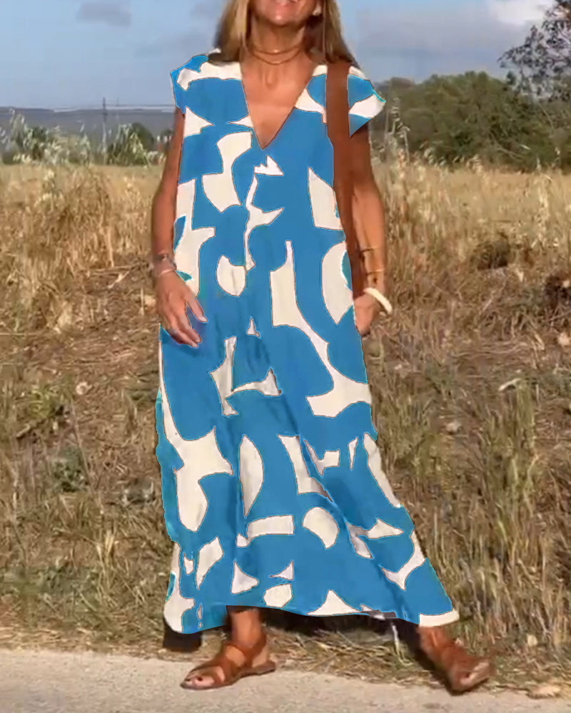 Stylish women's V-neck dress, abstract pattern. Flowy, cap sleeve. Comfortable for summer fashion.