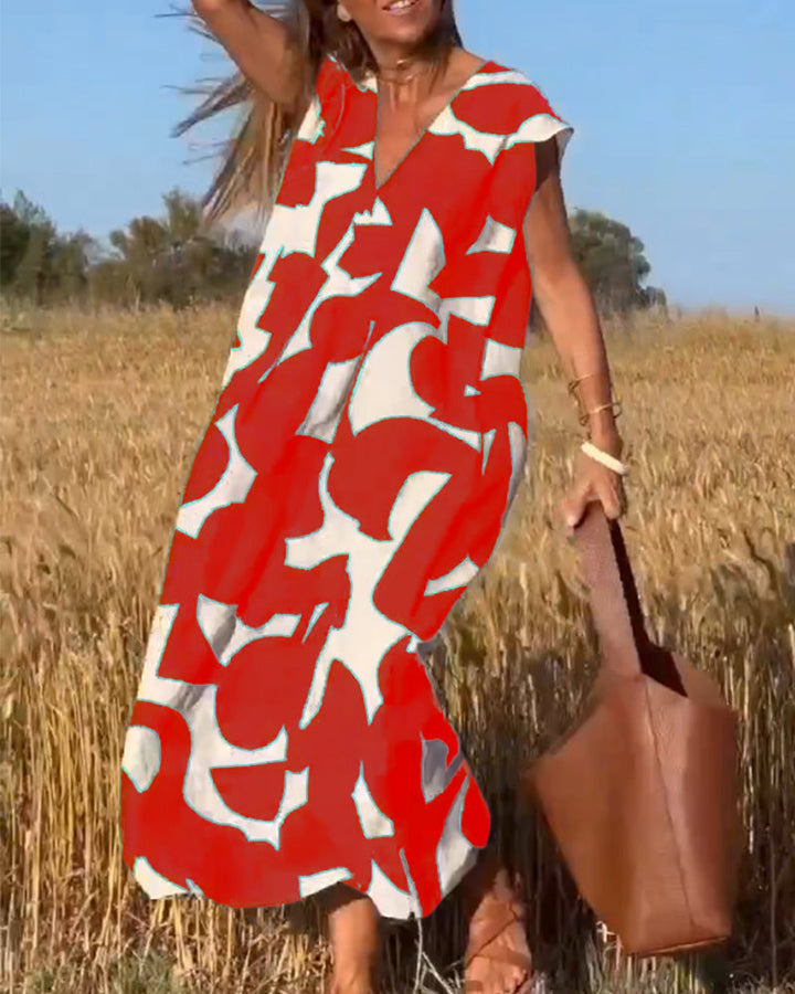 Comfortable women's abstract print dress. Stylish, flowy, V-neck, cap sleeve. Summer fashion.