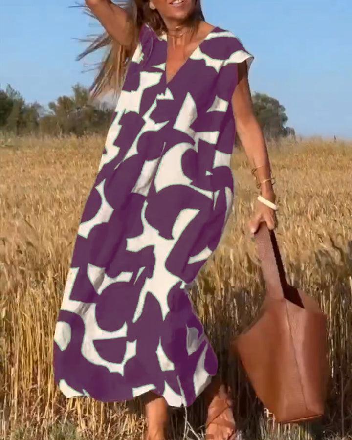 Stylish women's casual abstract dress. V-neck, flowy, cap sleeves. Perfect for summer comfort.