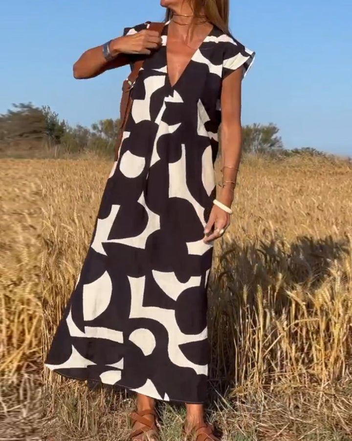 Flowy abstract print dress for women, cap sleeves. Stylish & comfortable for summer casual wear.