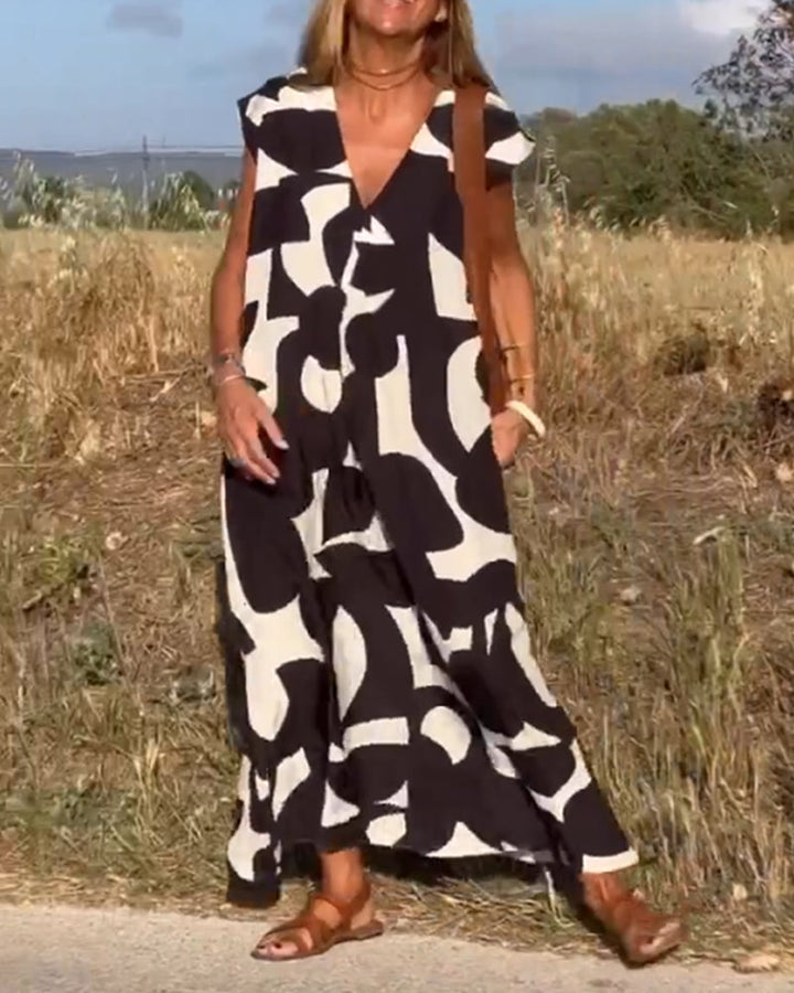 Stylish women's summer dress, relaxed fit. Abstract design, flowy cap sleeve for ultimate comfort.