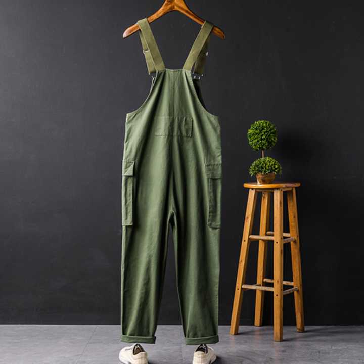 Woman modeling comfortable relaxed fit bib overalls, a stylish sleeveless jumpsuit for casual everyday wear.