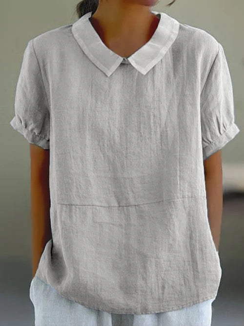 Dark blue women's Peter Pan collar blouse. Relaxed fit, short sleeve, vintage style casual summer wear.