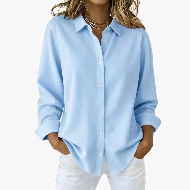 Front view of a women's relaxed fit long sleeve button up shirt, showcasing its comfortable style.