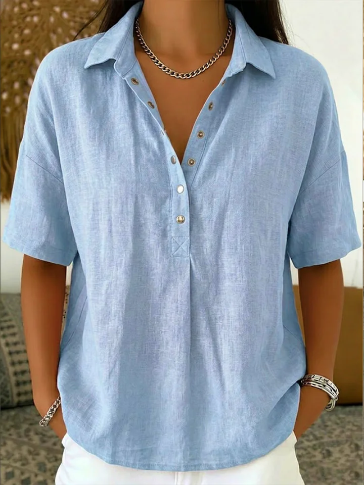 Chic women's collar shirt featuring a relaxed fit, short sleeves, & adjustable button details. Summer ready.