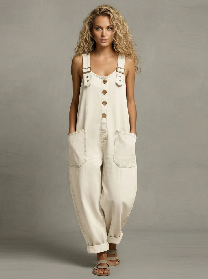 Stylish women's relaxed fit bib overalls in blue denim, offering easy, comfortable one-piece casual fashion.