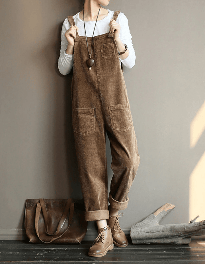 Women's relaxed fit dungaree jumpsuit with wide leg, adjustable straps & patch pockets. Perfect for casual autumn wear.