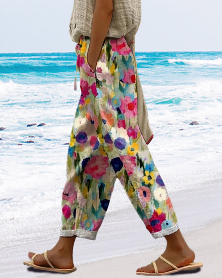 Vibrant multicolored floral print women's relaxed fit pants. Comfortable casual trousers, ideal for summer fashion.