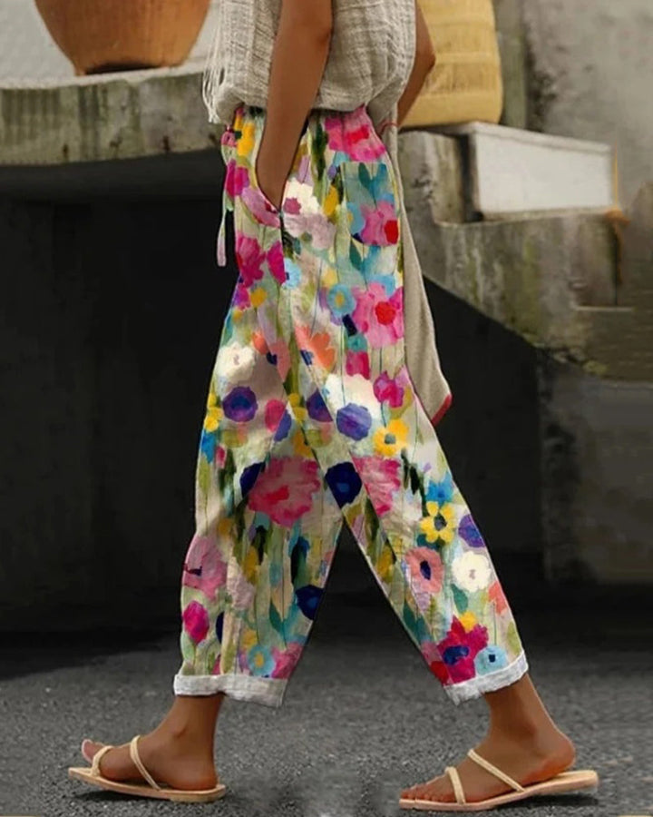 Comfortable women's relaxed fit trousers with artistic floral print. Perfect multicolored summer pants for casual style.