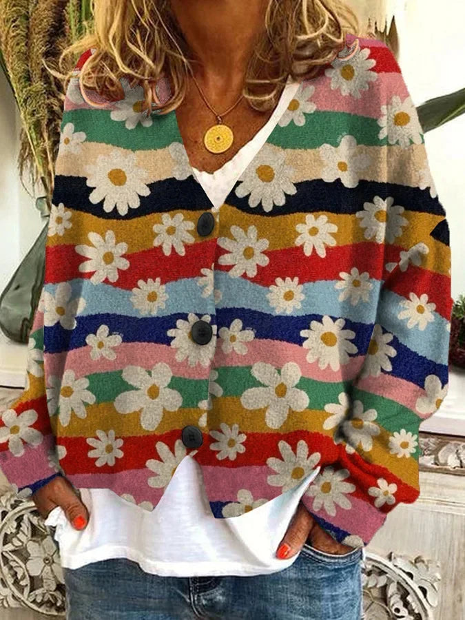 Close-up of vibrant floral stripe pattern on a women's relaxed fit button-up cardigan. Statement fashion.