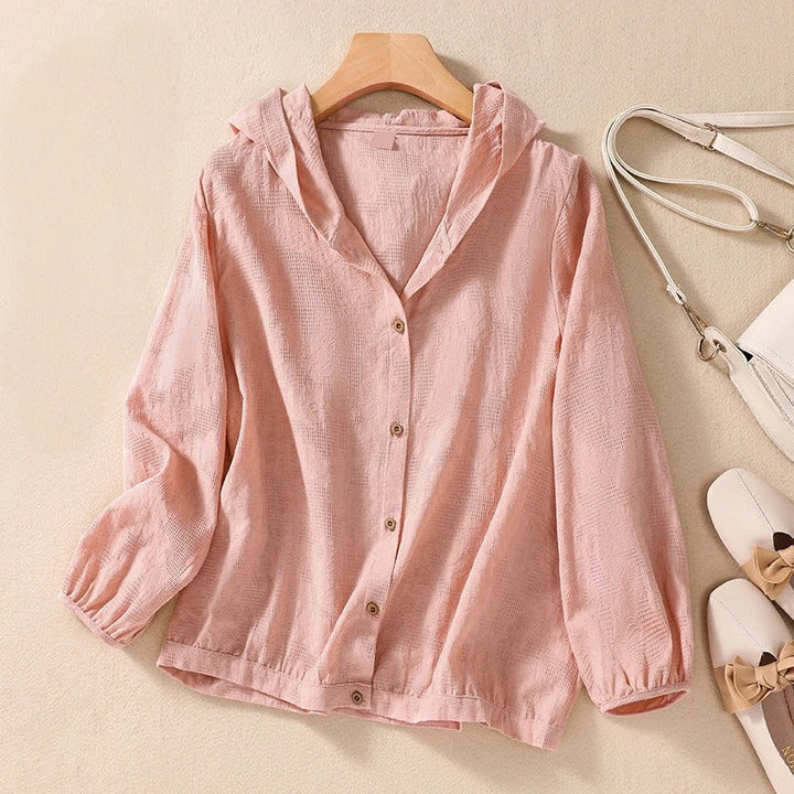 Comfortable women's relaxed fit hooded shirt in breathable fabric, great for spring and summer layering.