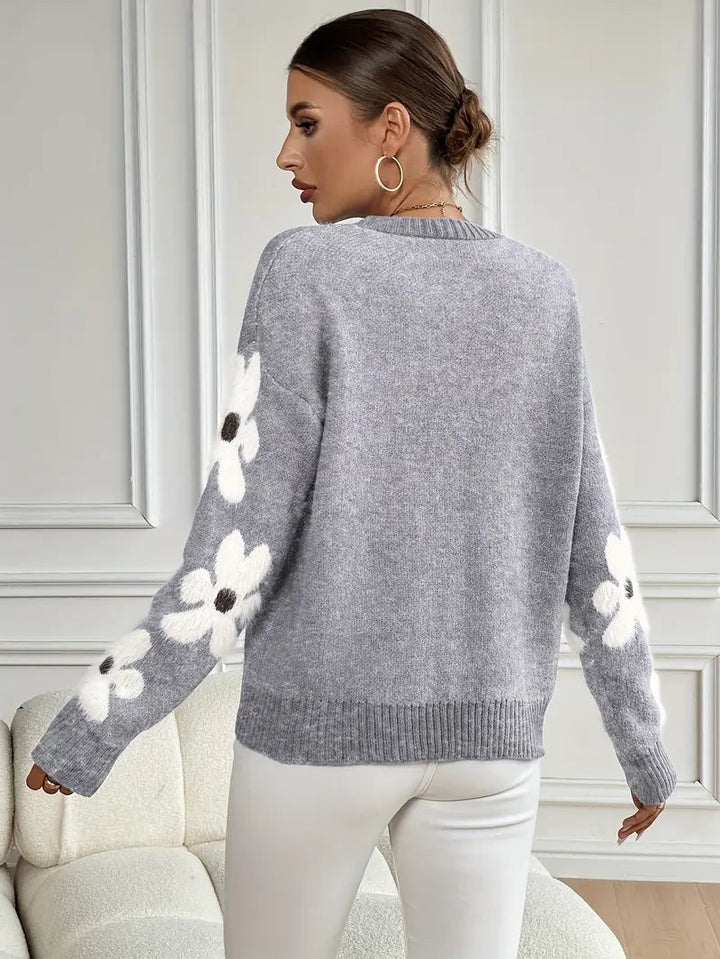 Casual women's long sleeve sweater in a relaxed fit, showcasing a vibrant daisy design.