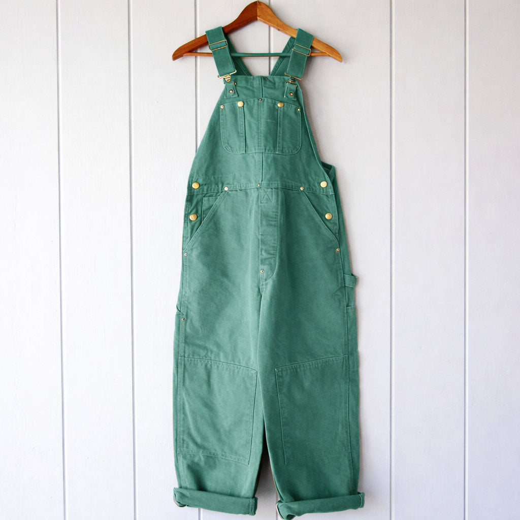 Full-length view of women's relaxed fit overalls, featuring adjustable straps for a custom, comfortable fit.
