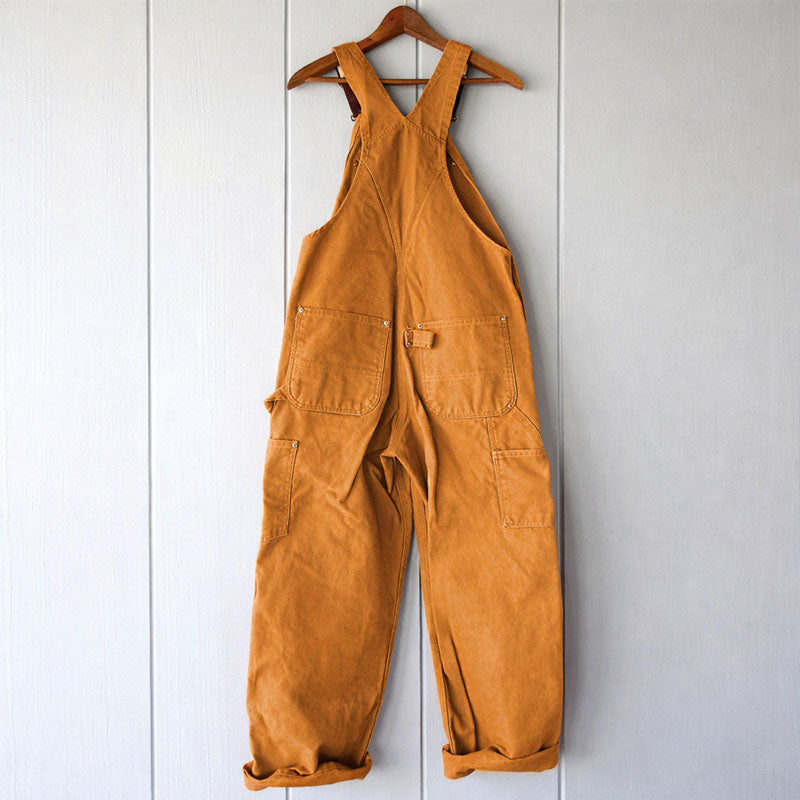 Model wearing women's relaxed fit overalls, showcasing a comfortable, sleeveless design and versatile utility pockets.