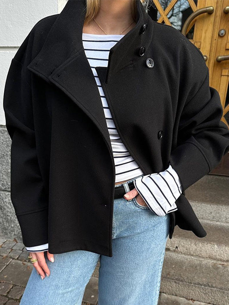 Versatile women's short coat with a relaxed fit, high neck, and elegant button closure. Great for everyday casual style.
