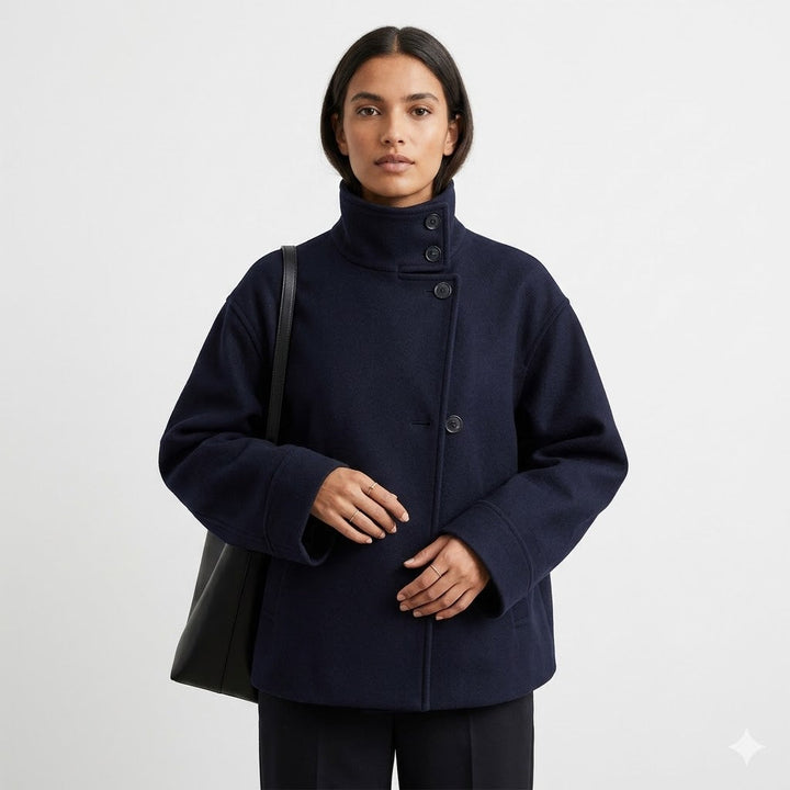 Modern women's relaxed fit short coat. Designed with a high neck & classic button closure for chic casual outerwear.