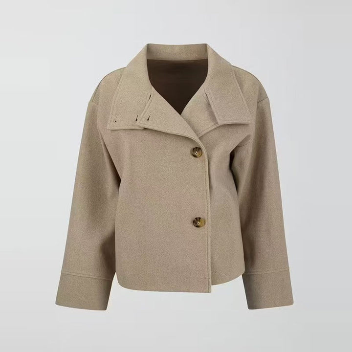 Front view of a women's relaxed fit short coat, showcasing the high neck & button closure. Stylish fall fashion jacket.