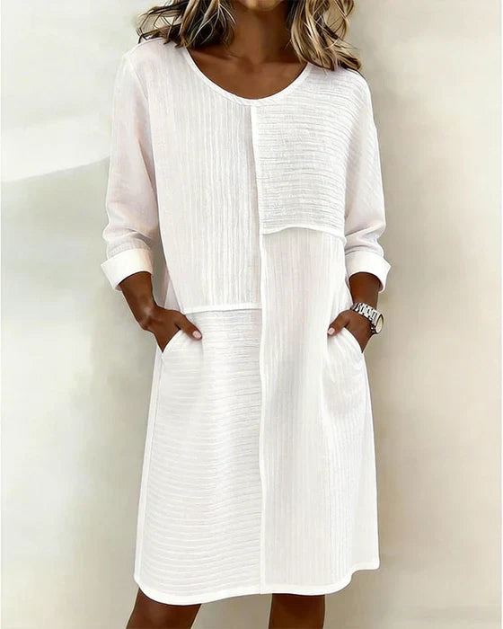Women's relaxed fit textured shift dress with convenient side pockets. Perfect for casual comfort.